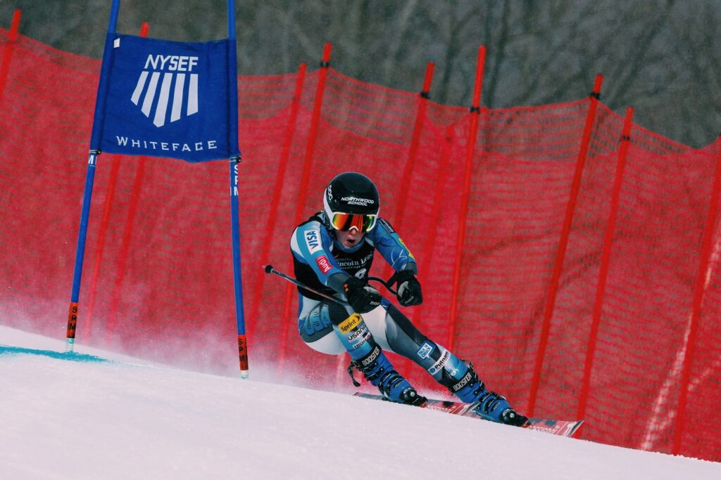 a young ski racer skis around a gate during a ski race