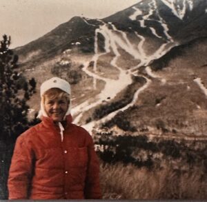 Skier stands in front of Whiteface Mountain in an old photographer