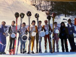 skiers pose with skis