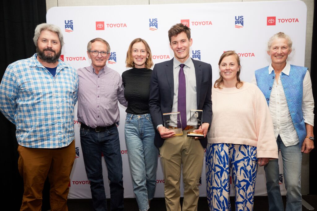 NYSEF ski jumping coach poses with NYSEF staff at award ceremony