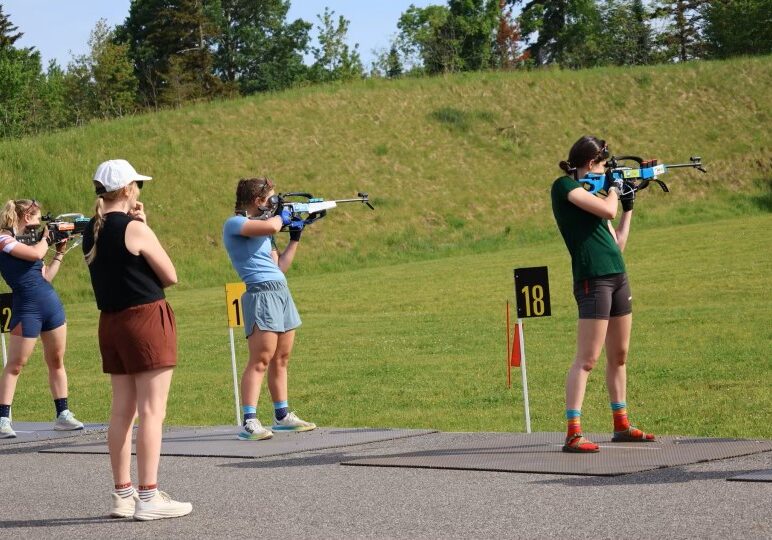 Maddie, Nysef's biathlon coach helping athletes on the range